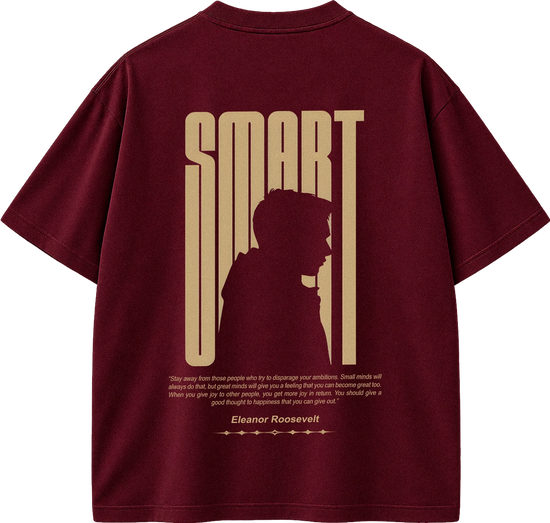 A maroon short-sleeve t-shirt shown from the back, featuring a large gold graphic print with the word 'SMART' in a vertical stylized font, a silhouette of a person, and a quote attributed to Eleanor Roosevelt.
