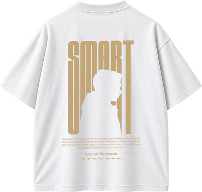 White short-sleeve T-shirt shown from the back with a large gold graphic print. The design features the word 'SMART' in tall vertical letters, a silhouette of a person, a quote by Eleanor Roosevelt, and smaller text below.