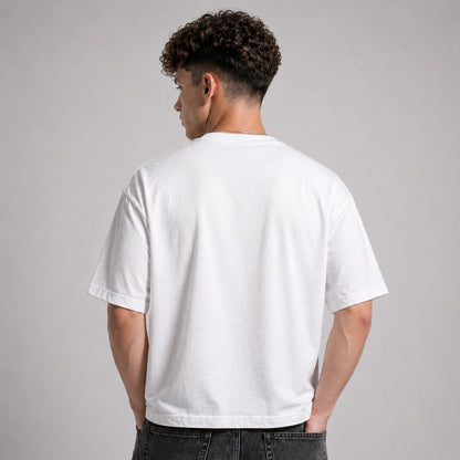 Person wearing a plain white t-shirt against a gray background