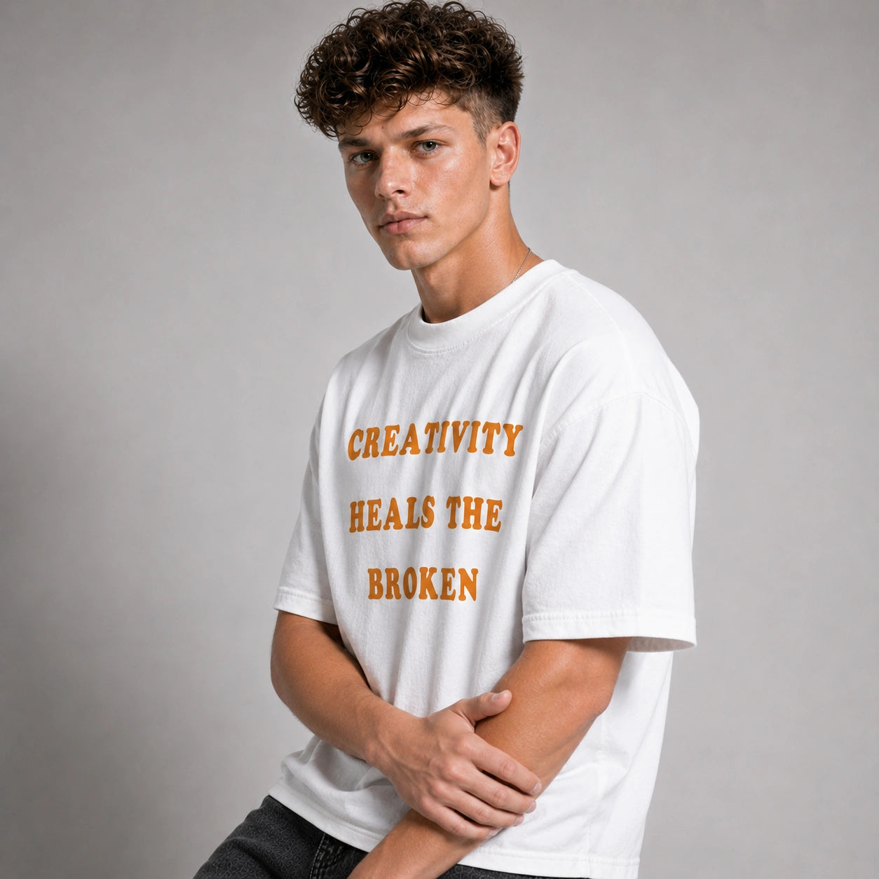 Person wearing a white t-shirt with text on a gray background