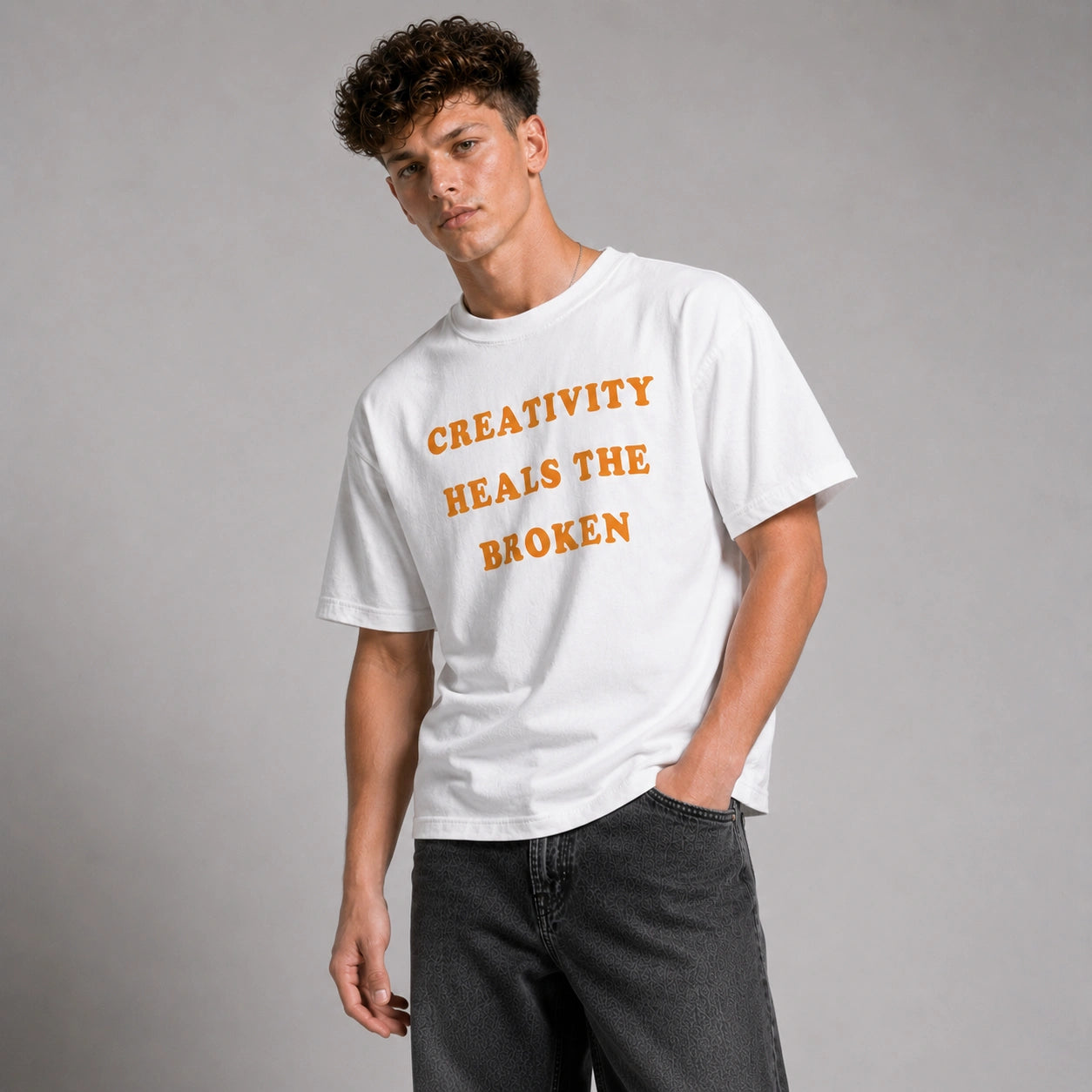 Person wearing a white t-shirt with orange text on a gray background