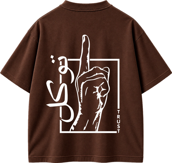 A brown short-sleeve t-shirt shown from the back, featuring a large white graphic print of a hand pointing upwards inside a square outline, with stylized lettering and the word 'TRUST' printed vertically.