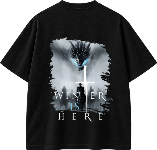 A black short-sleeve t-shirt with a large graphic print on the back. The graphic features a dark dragon with glowing blue eyes above a silhouette of a person holding a sword, with the text 'WINNER IS HERE' written below in white and light blue.