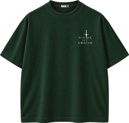 A dark forest green short-sleeve t-shirt with a small white graphic on the left chest featuring a cross and the text 'WINTER IS COMING'.
