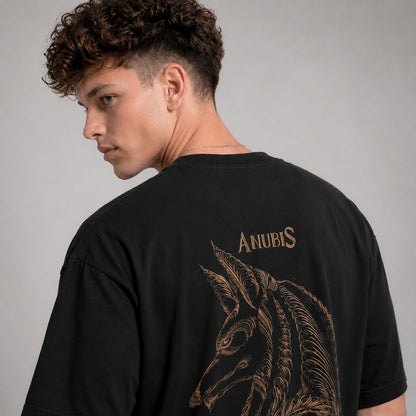 Person wearing a black t-shirt with 'Anubis' design on the back against a gray background