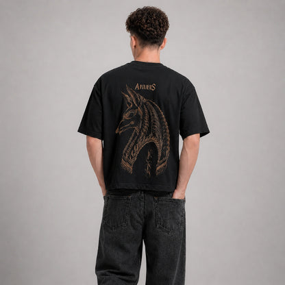 Person wearing a black t-shirt with a dragon design on the back against a gray background