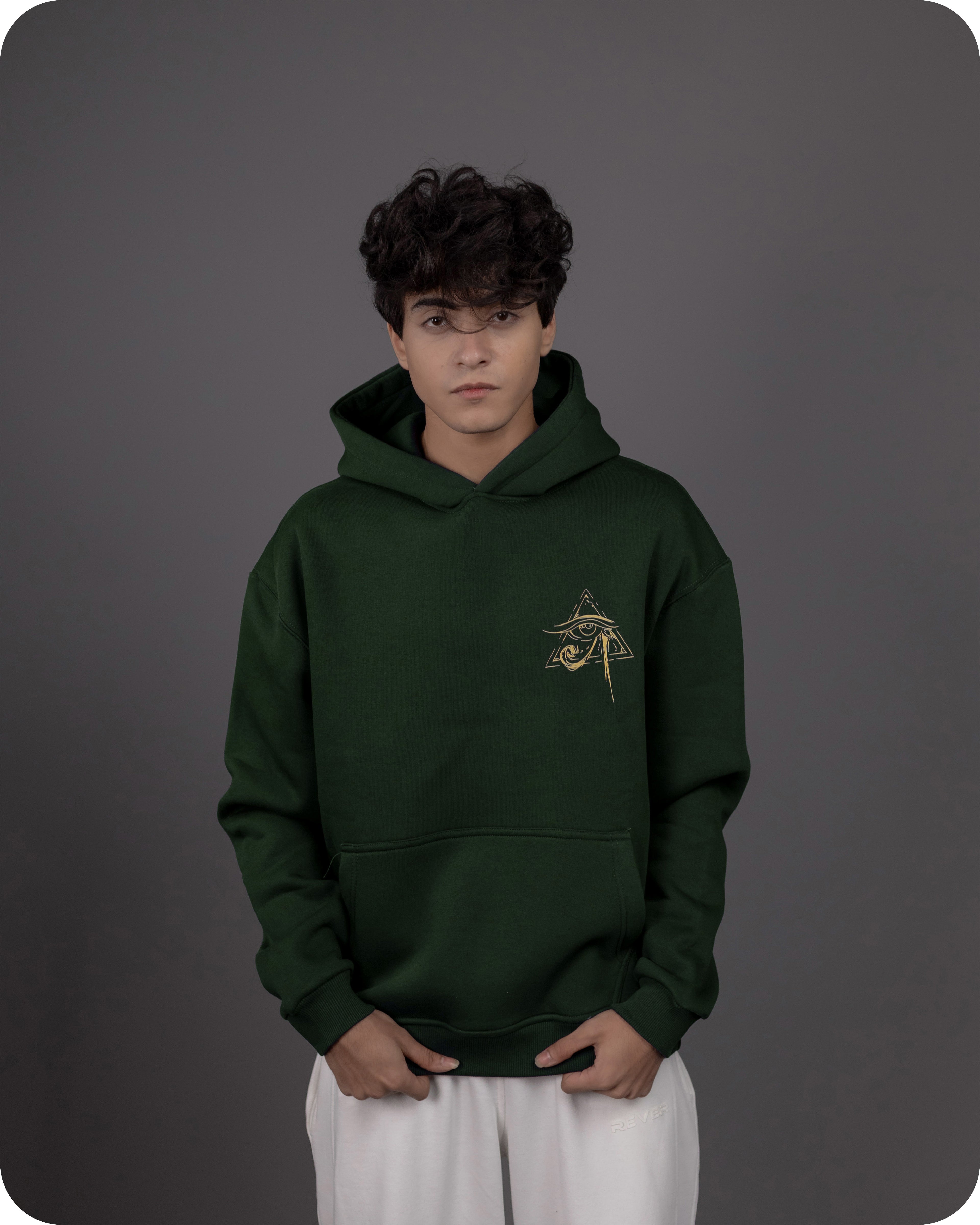 Person wearing a green hoodie with a logo on a gray background