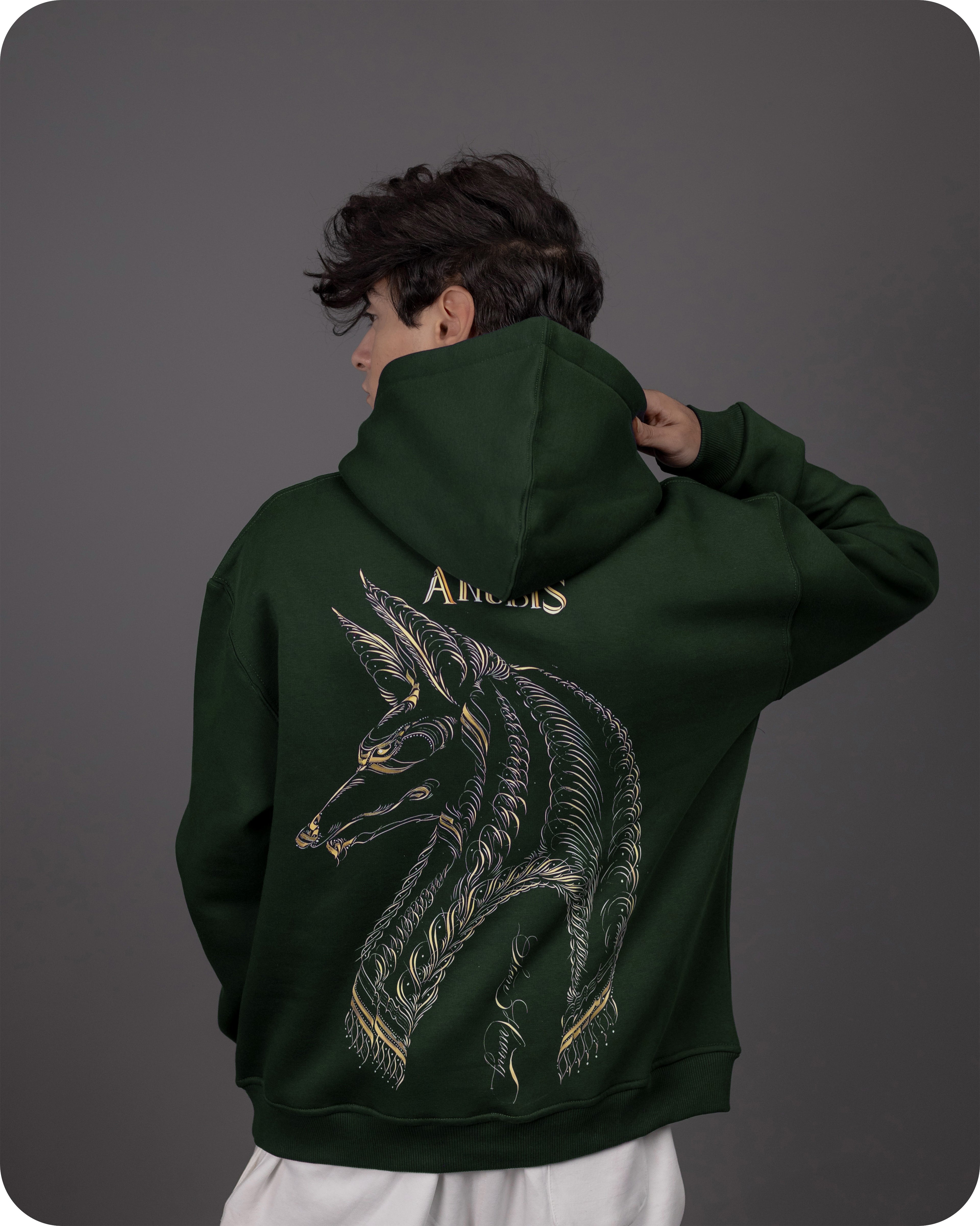 Person wearing a green hoodie with a dragon design and 'Angels' text on the back against a gray background