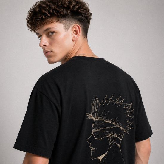 Person wearing a black t-shirt with a design on the back against a gray background