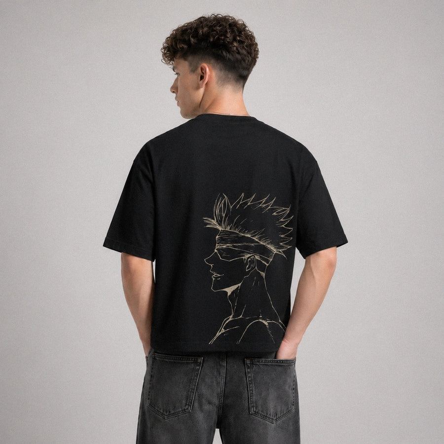 Person wearing a black t-shirt with a design on the back against a gray background
