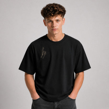 Person wearing a black t-shirt with a logo on a gray background