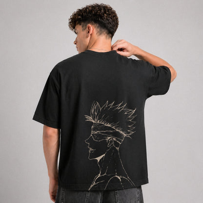 Person wearing a black t-shirt with a design on the back against a gray background