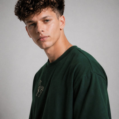 Man wearing a green sweatshirt with a logo on a gray background