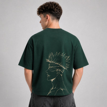 Person wearing a green t-shirt with a graphic design on the back against a gray background