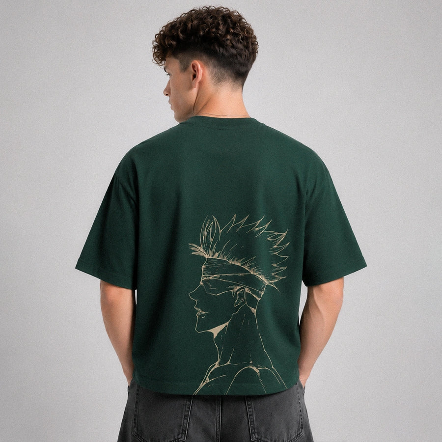 Person wearing a green t-shirt with a graphic design on the back against a gray background