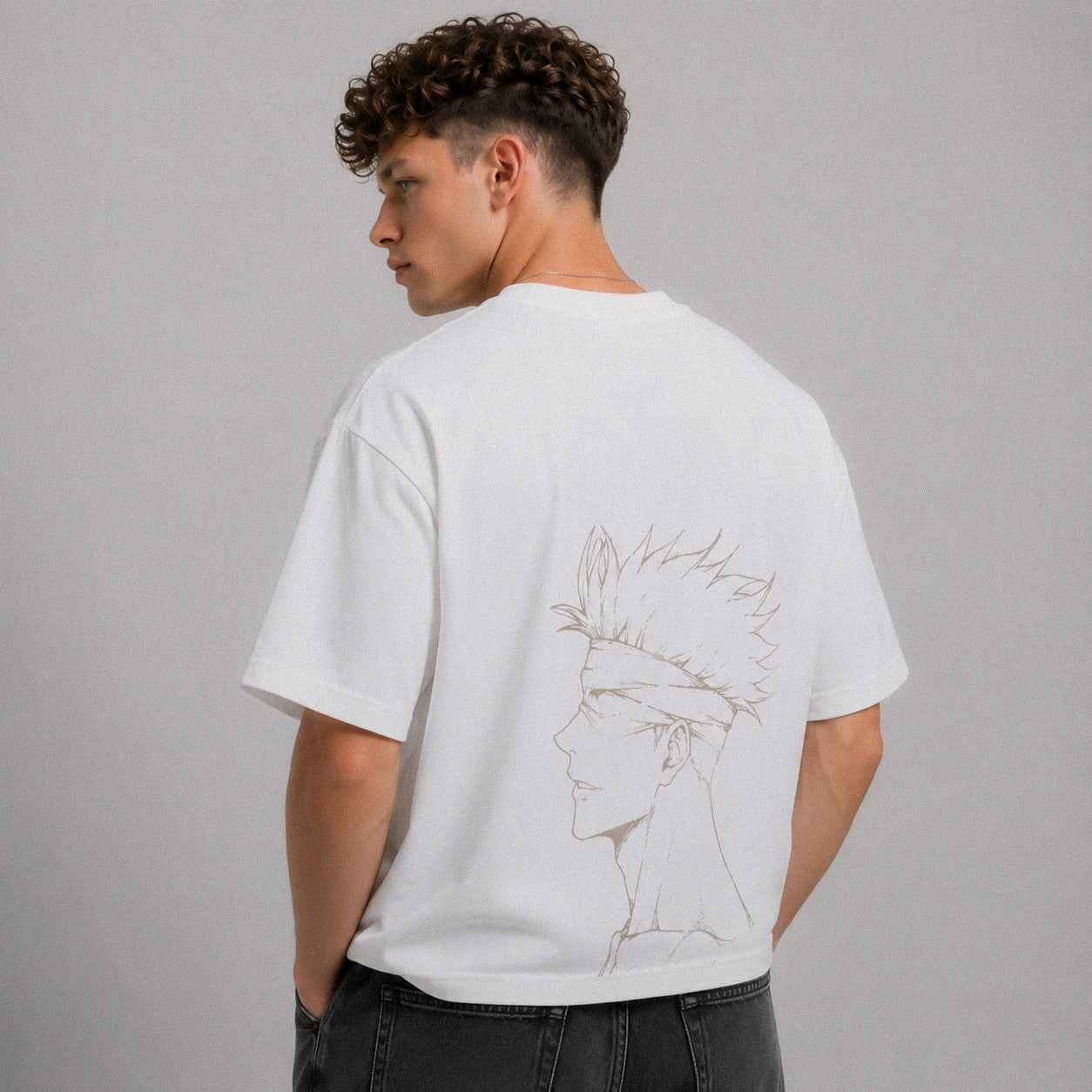 Person wearing a white t-shirt with a design on the back against a gray background