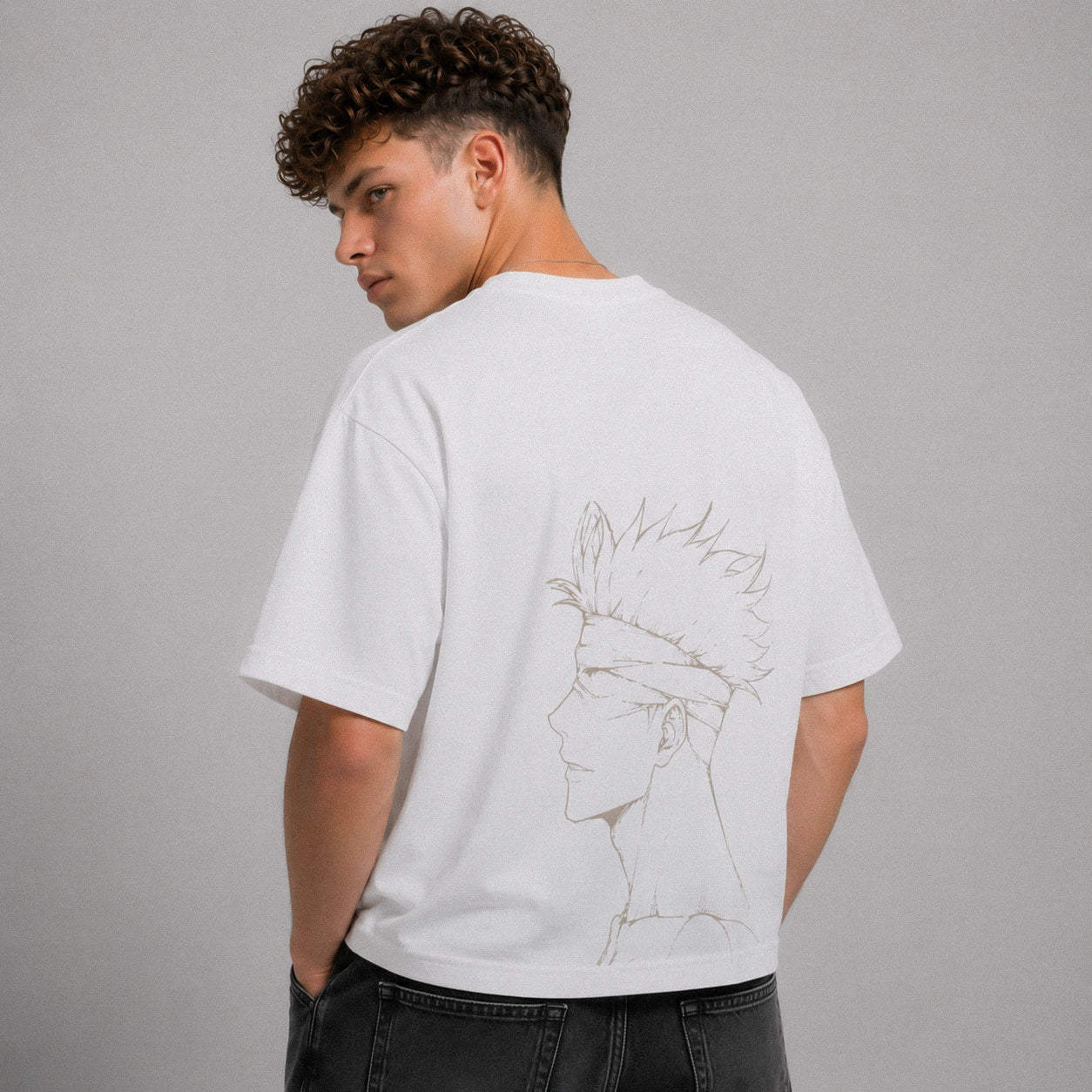 Person wearing a white t-shirt with a graphic design on the back against a gray background