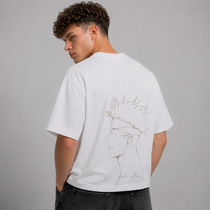 Person wearing a white t-shirt with a graphic design on the back against a gray background