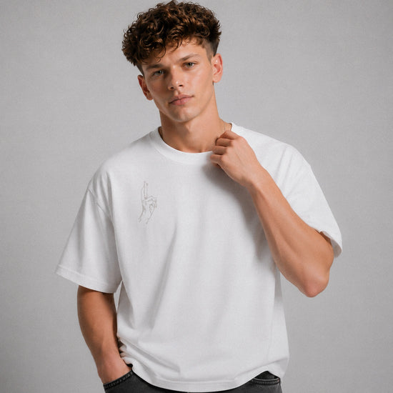 Man wearing a white t-shirt with a small design on a gray background