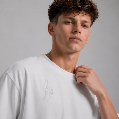 Man wearing a white t-shirt against a gray background