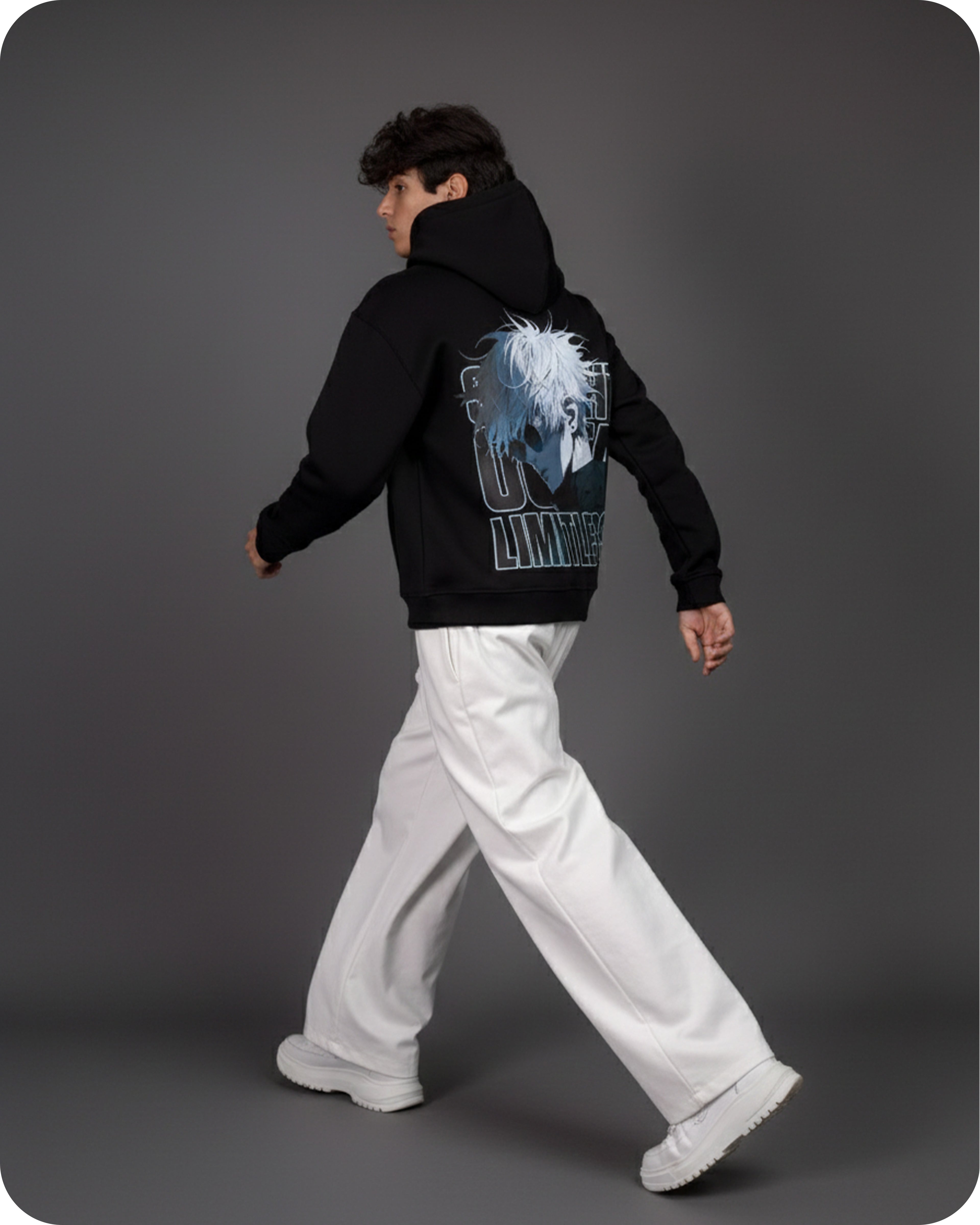 Person wearing a black hoodie with a graphic design on the back against a gray background