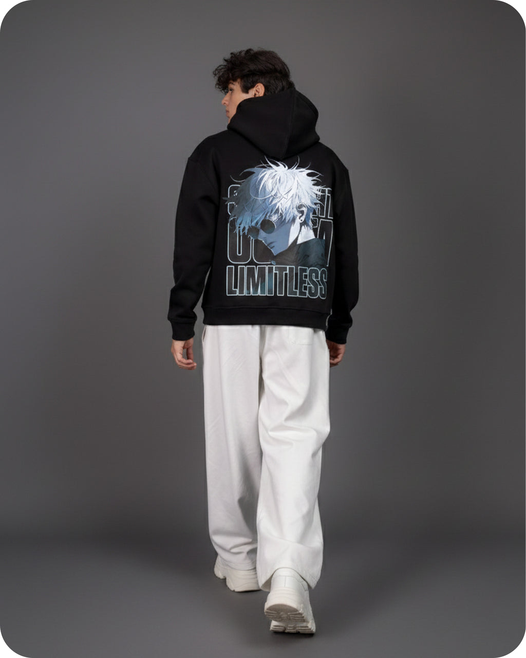 Person wearing a black hoodie with a graphic design on the back against a gray background