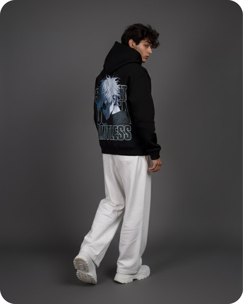 Person wearing a black hoodie with graphic design on the back against a gray background