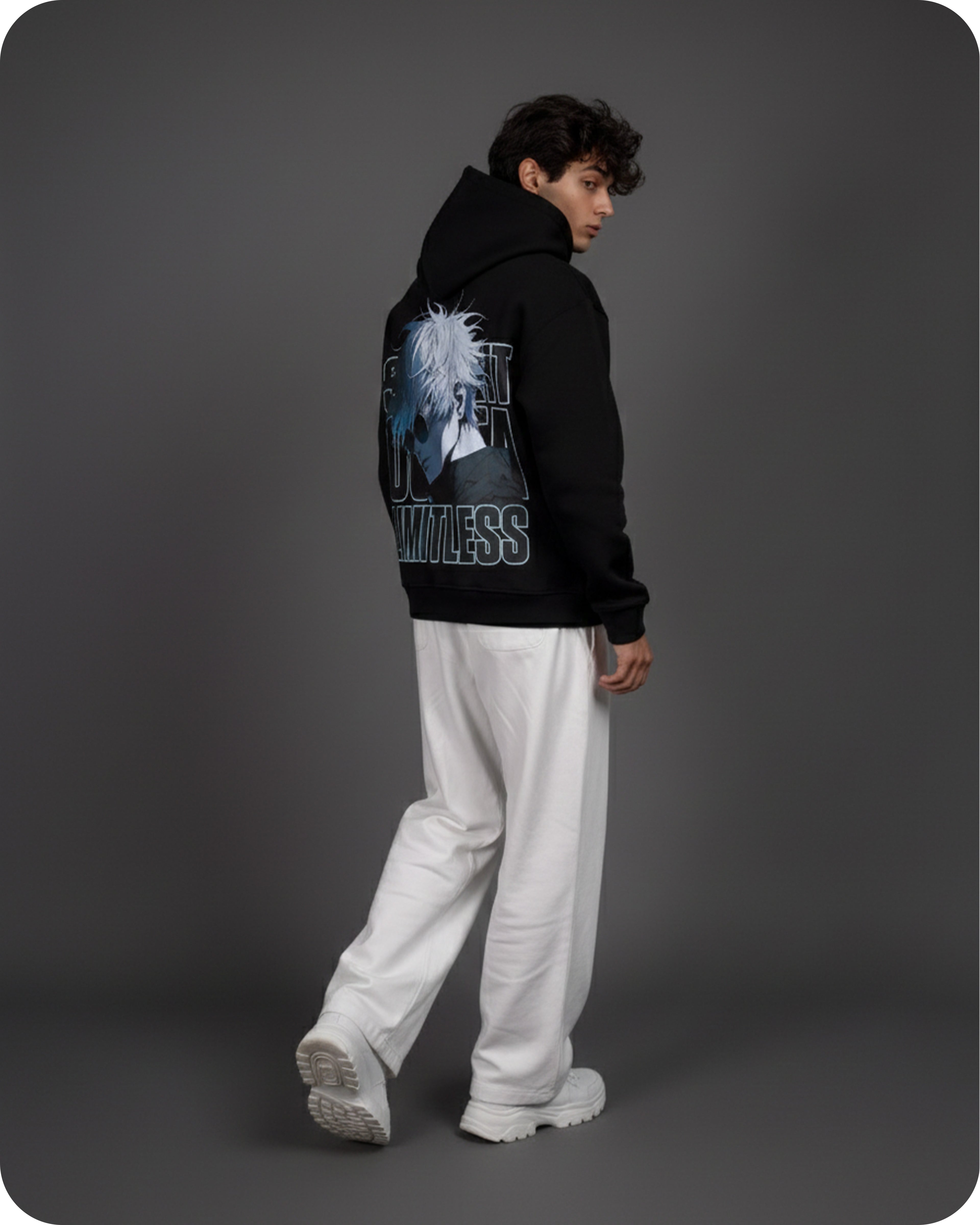 Person wearing a black hoodie with graphic design on the back against a gray background