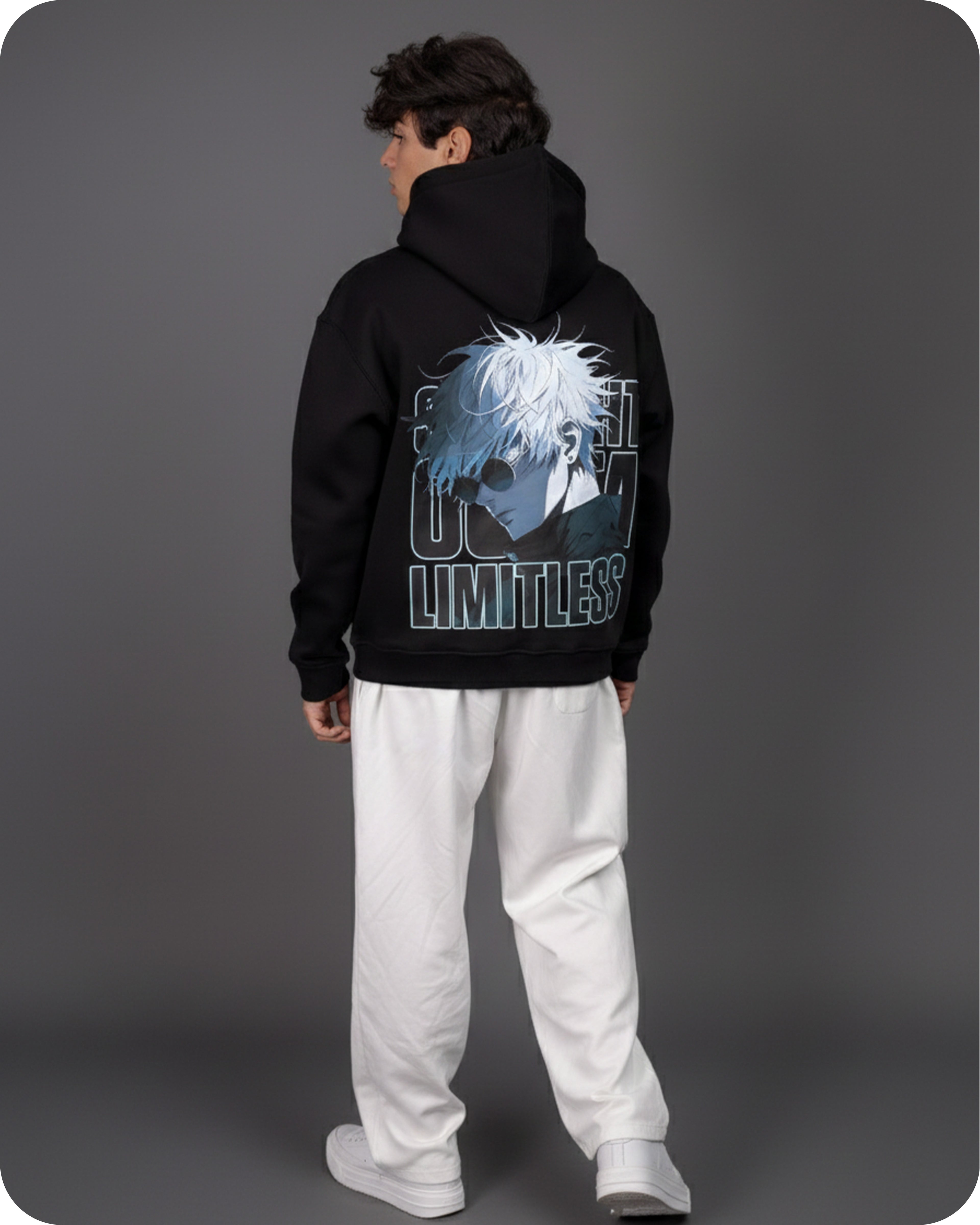 Person wearing a black hoodie with a graphic design on the back against a gray background