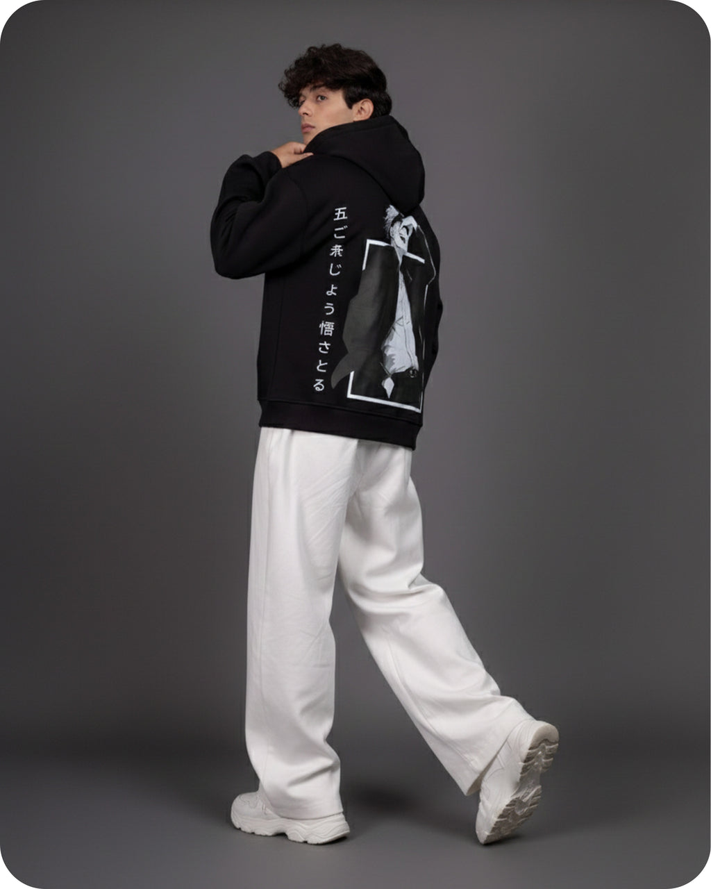 Person wearing a black hoodie with white text and graphics on a gray background