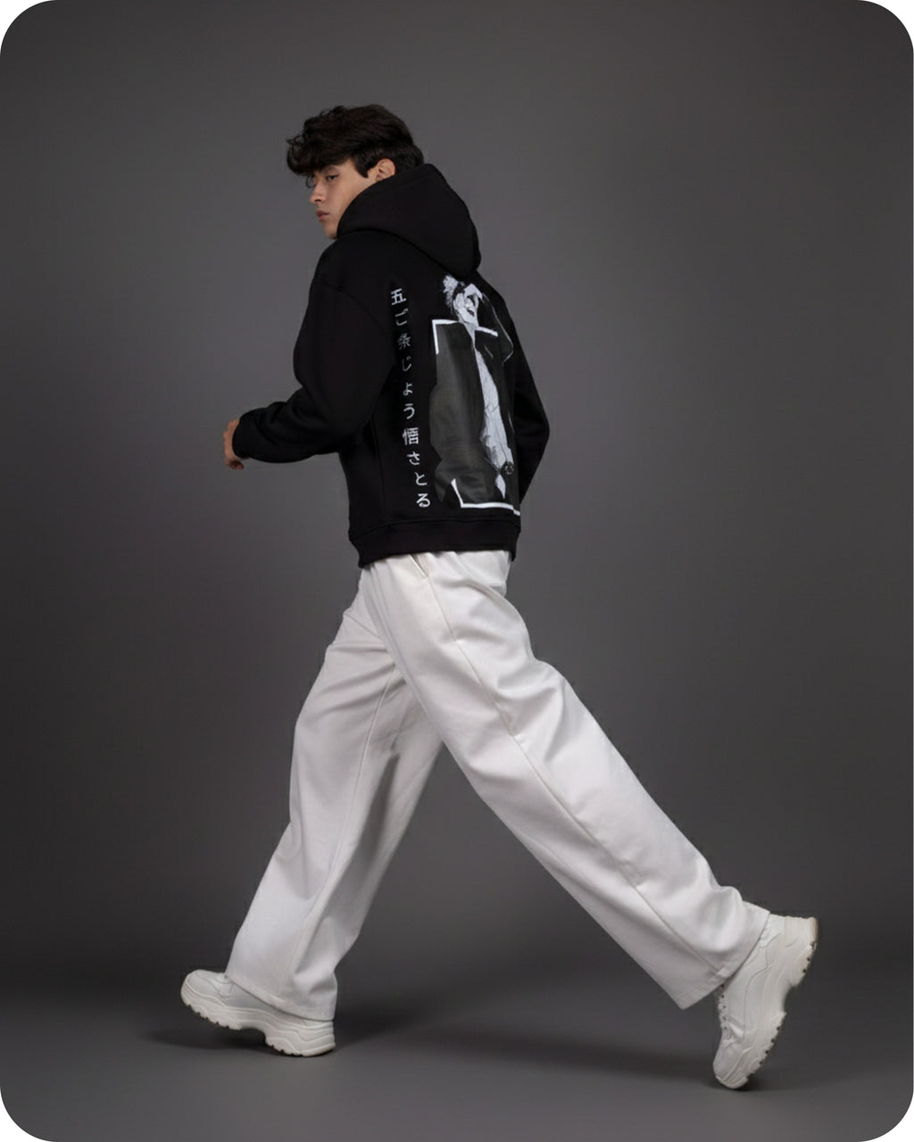 Person wearing a black jacket with a graphic design on a gray background