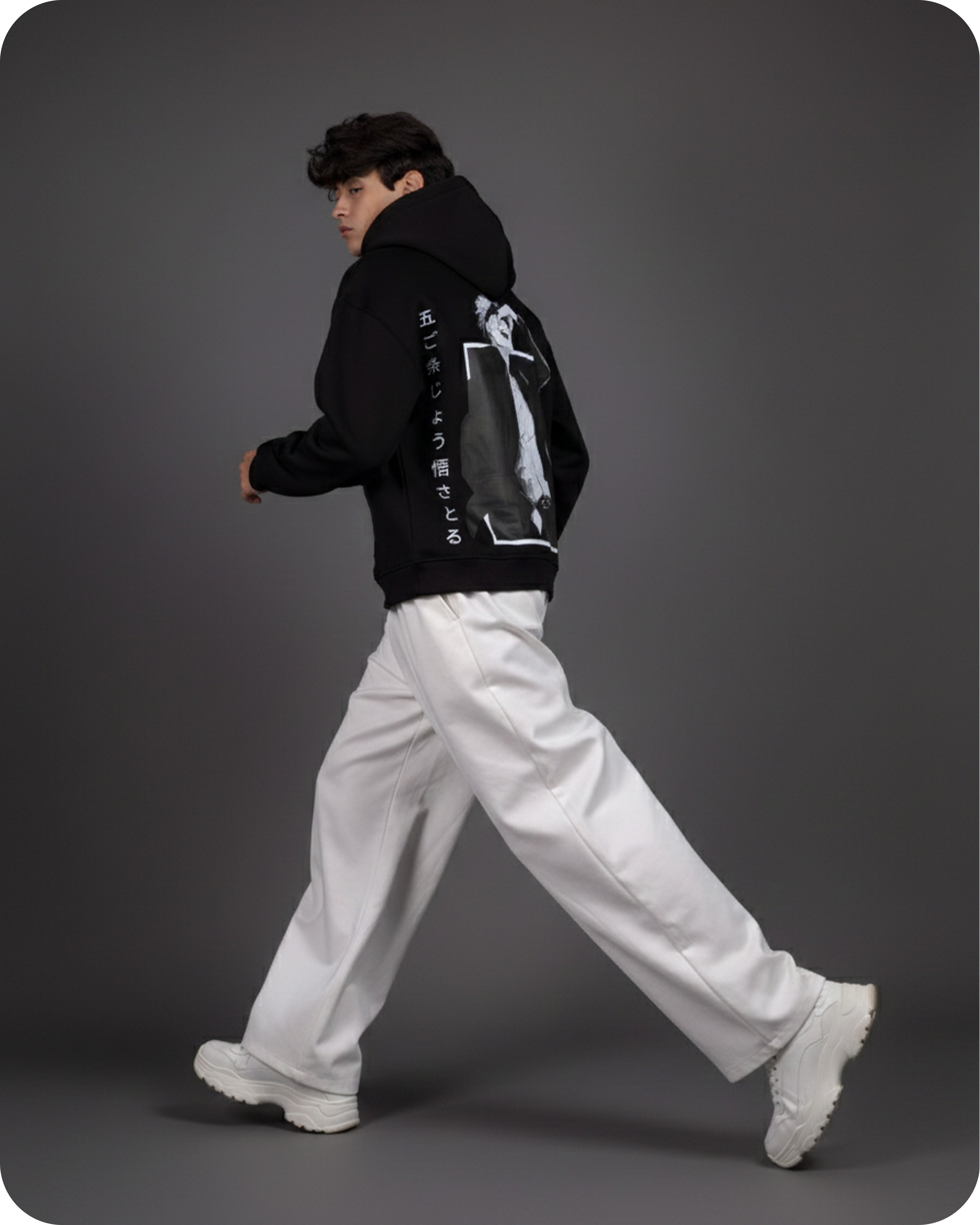 Person wearing a black jacket with a graphic design on a gray background