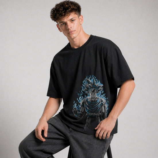Person wearing a black t-shirt with a graphic design on a plain background