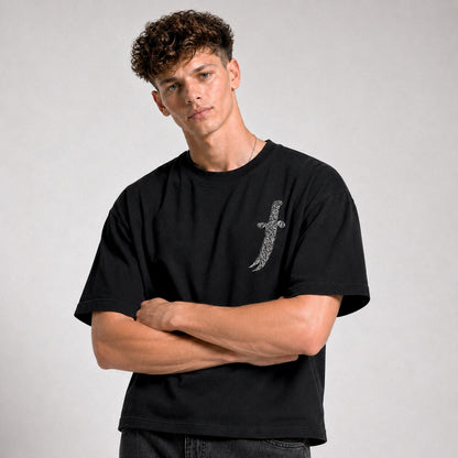 Man wearing a black t-shirt with a design on a plain background