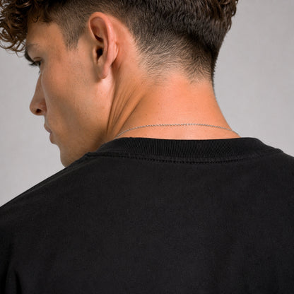 Man wearing a black shirt with a plain background