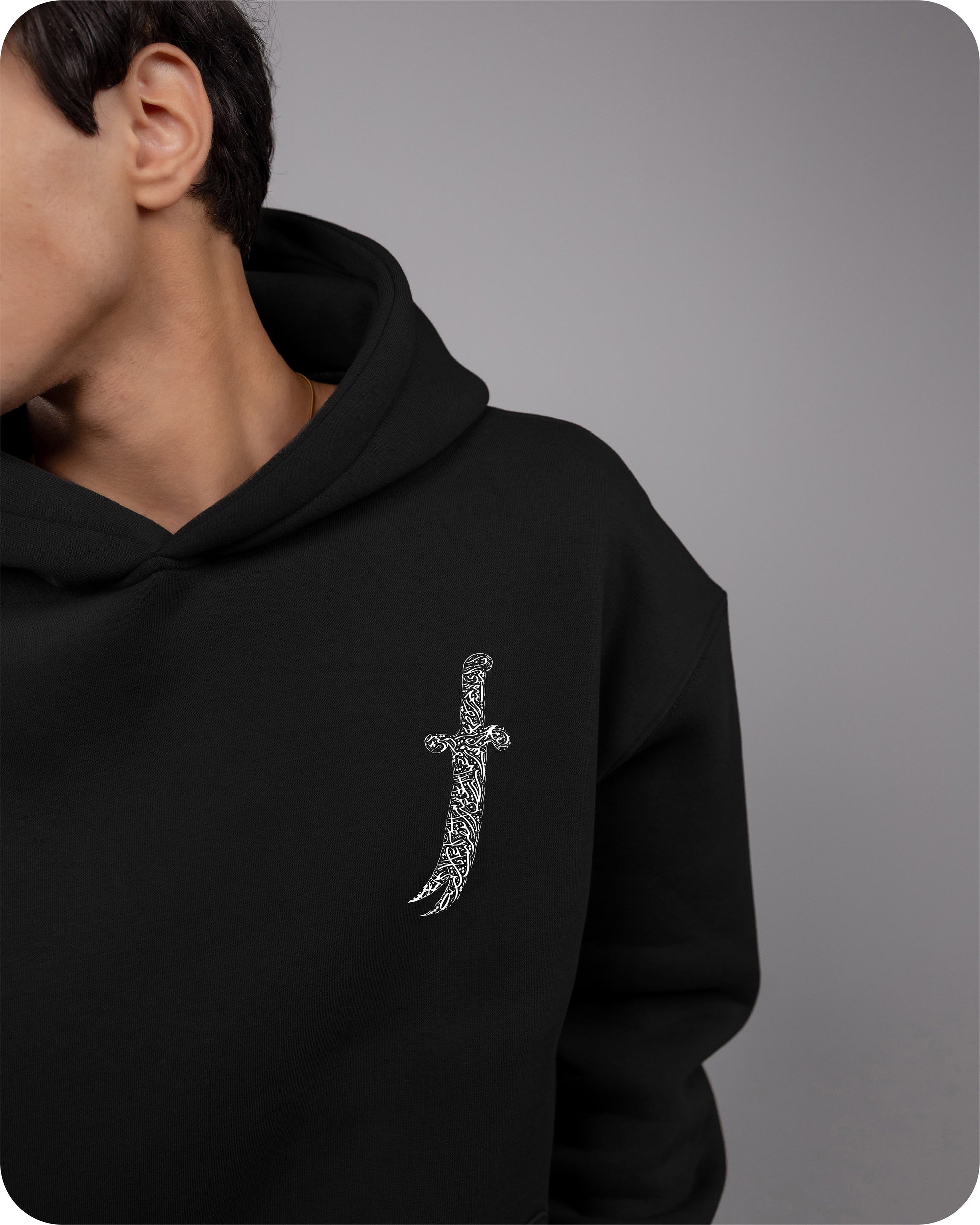 Black hoodie with a silver cross design on a gray background