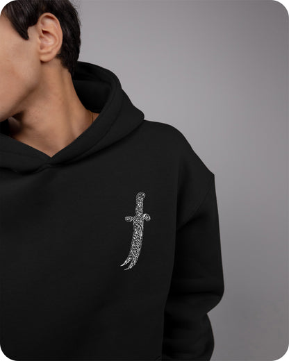 Black hoodie with a silver cross design on a gray background