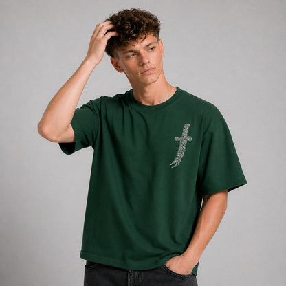 Man wearing a green t-shirt with a logo on a gray background