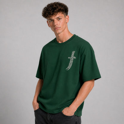 Man wearing a green t-shirt with a unique design on a gray background