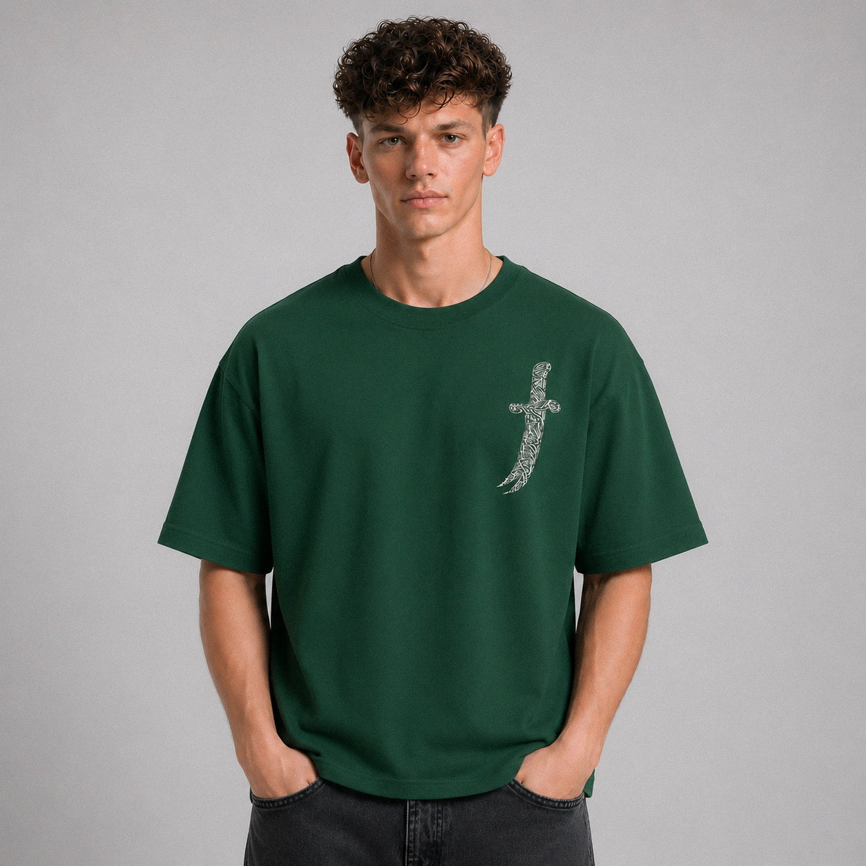 Man wearing a green t-shirt with a small design on a gray background
