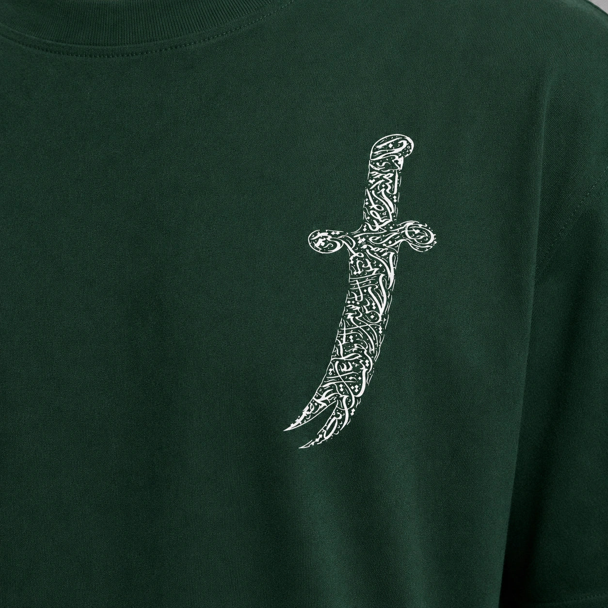 Green t-shirt with a white dagger design on a plain background