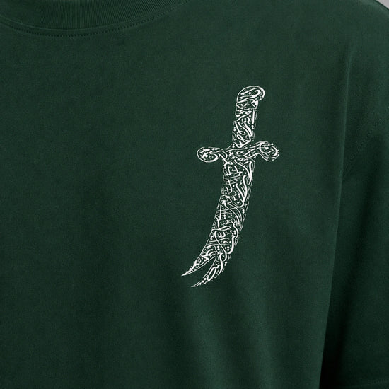 Green t-shirt with a white dagger design on a plain background