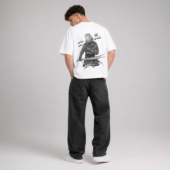 Person wearing a white t-shirt with a graphic design on the back, standing against a plain background.