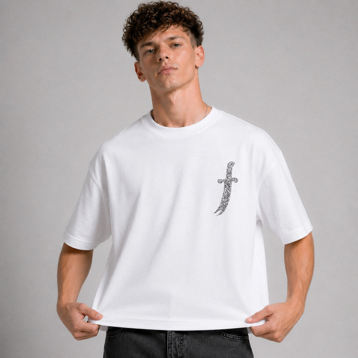 Man wearing a white t-shirt with a graphic design on a gray background