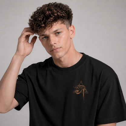Man wearing a black t-shirt with a logo on a gray background