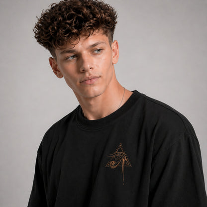 Man wearing a black sweatshirt with a logo on a gray background