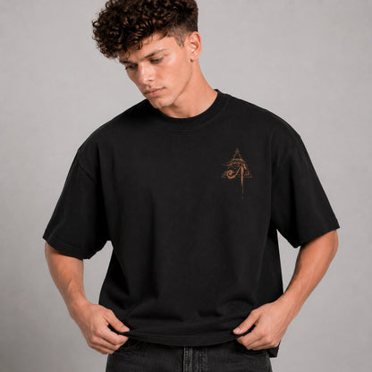 Man wearing a black t-shirt with a logo on a gray background
