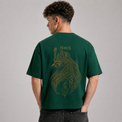 Person wearing a green t-shirt with a gold graphic and 'Horus' text on the back, against a gray background