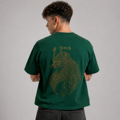 Person wearing a green t-shirt with a gold graphic and 'Horus' text on the back, against a gray background