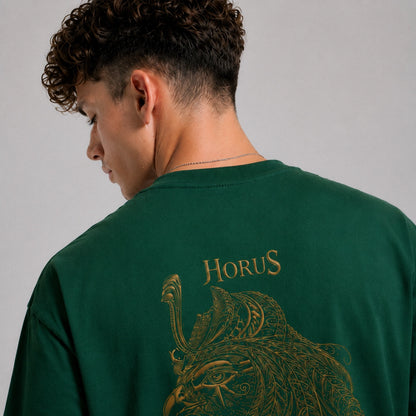 Person wearing a green sweatshirt with 'Horus' design on the back